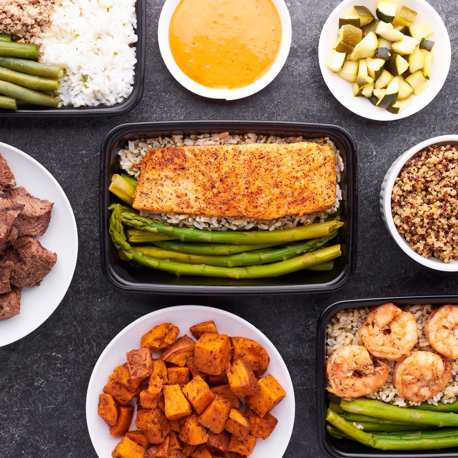 Meal prep containers with salmon, vegetables and sweet potato